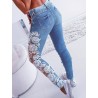Seksowne jeansy skinny - wycięte spodnie z kwiatową koronkąSpodnie